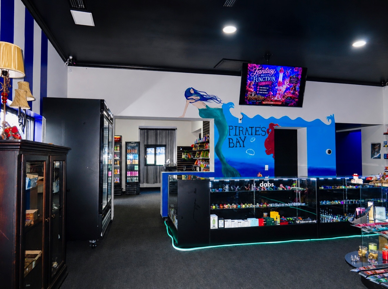 Pirates Bay interior with mermaid mural, coolers and neon lighting
